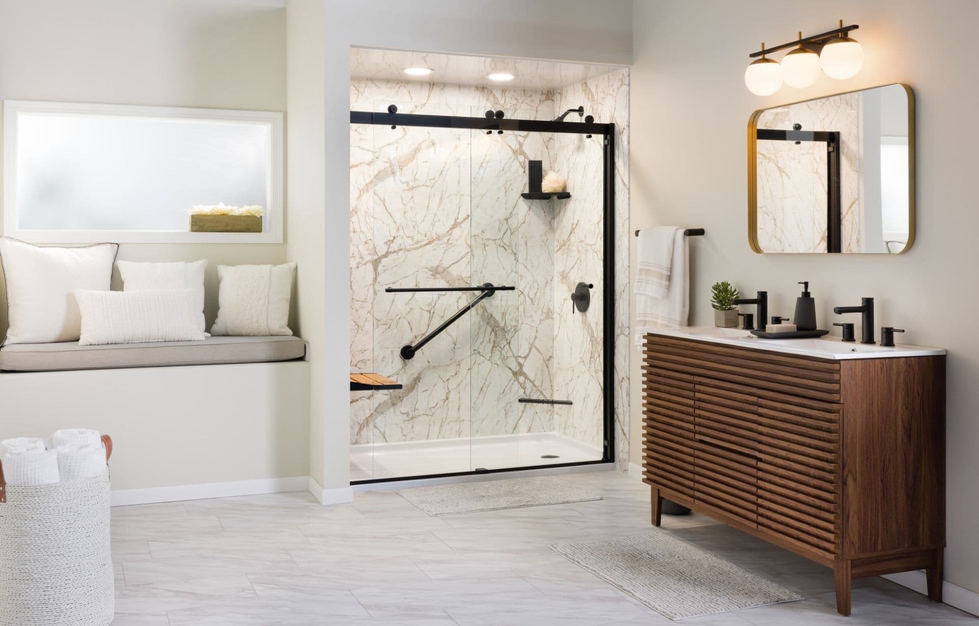 Modern bathroom featuring marble tile shower with black frame, wood vanity with mirror, window nook with seating, and brass pendant lighting