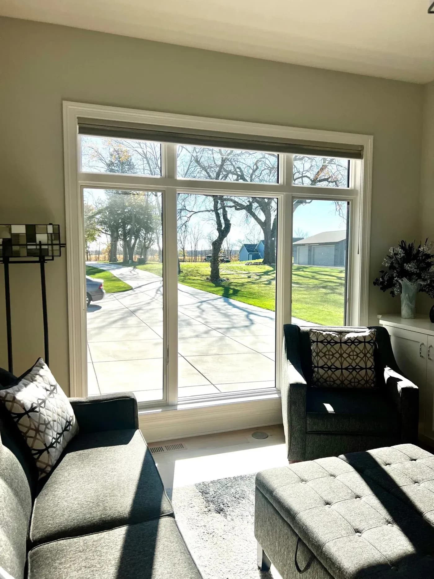 Large vinyl replacement window with transom windows bringing natural light into a living room in Germantown, Wisconsin.